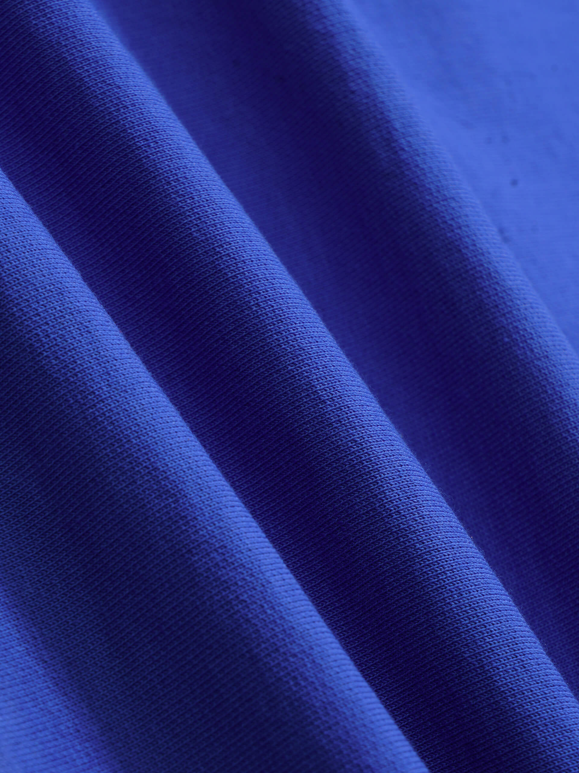 blue cotton t-shirt fabric close up showing texture