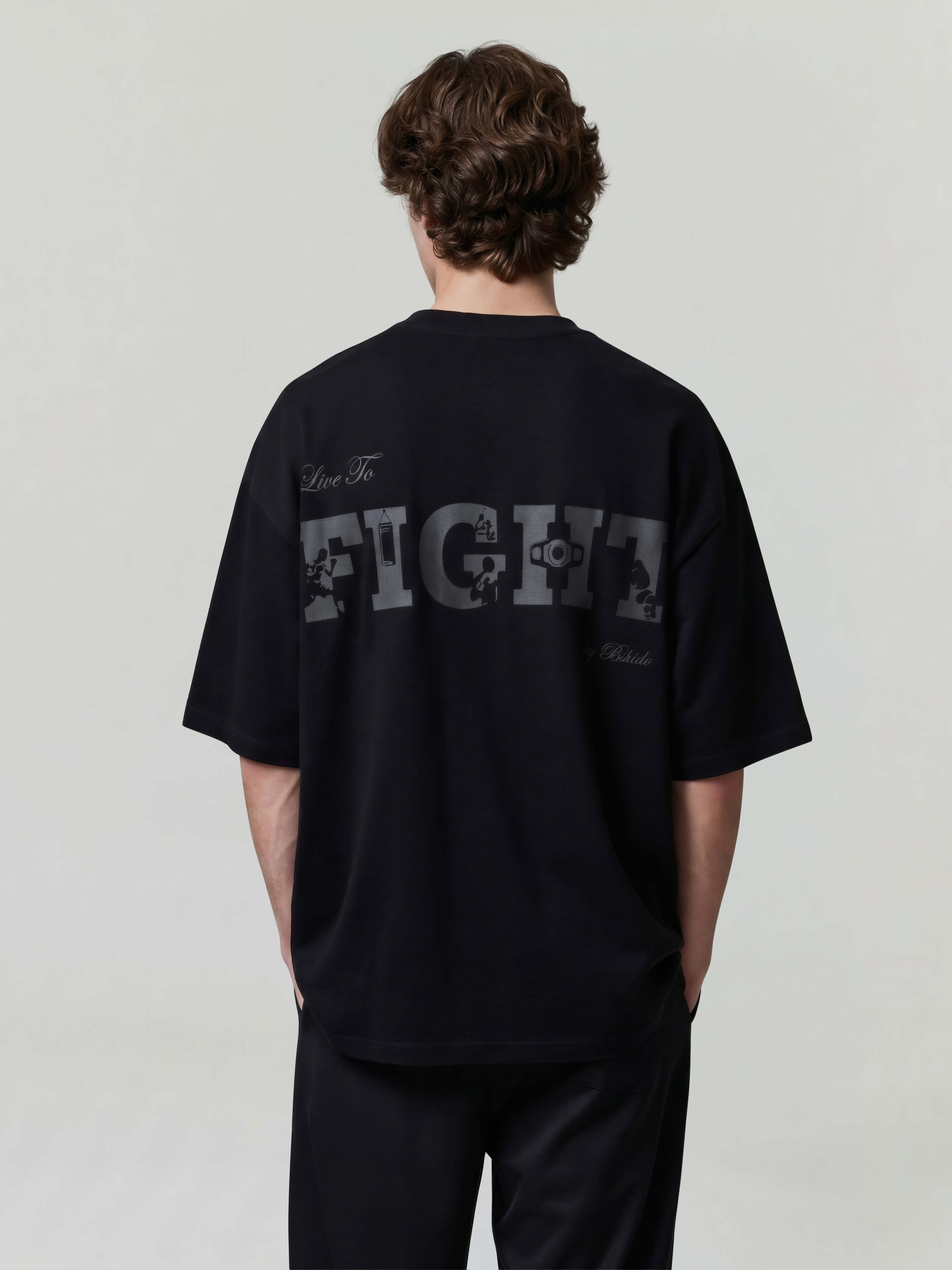 Black oversized Bshido t-shirt back view showing “Live To Fight” graphic print