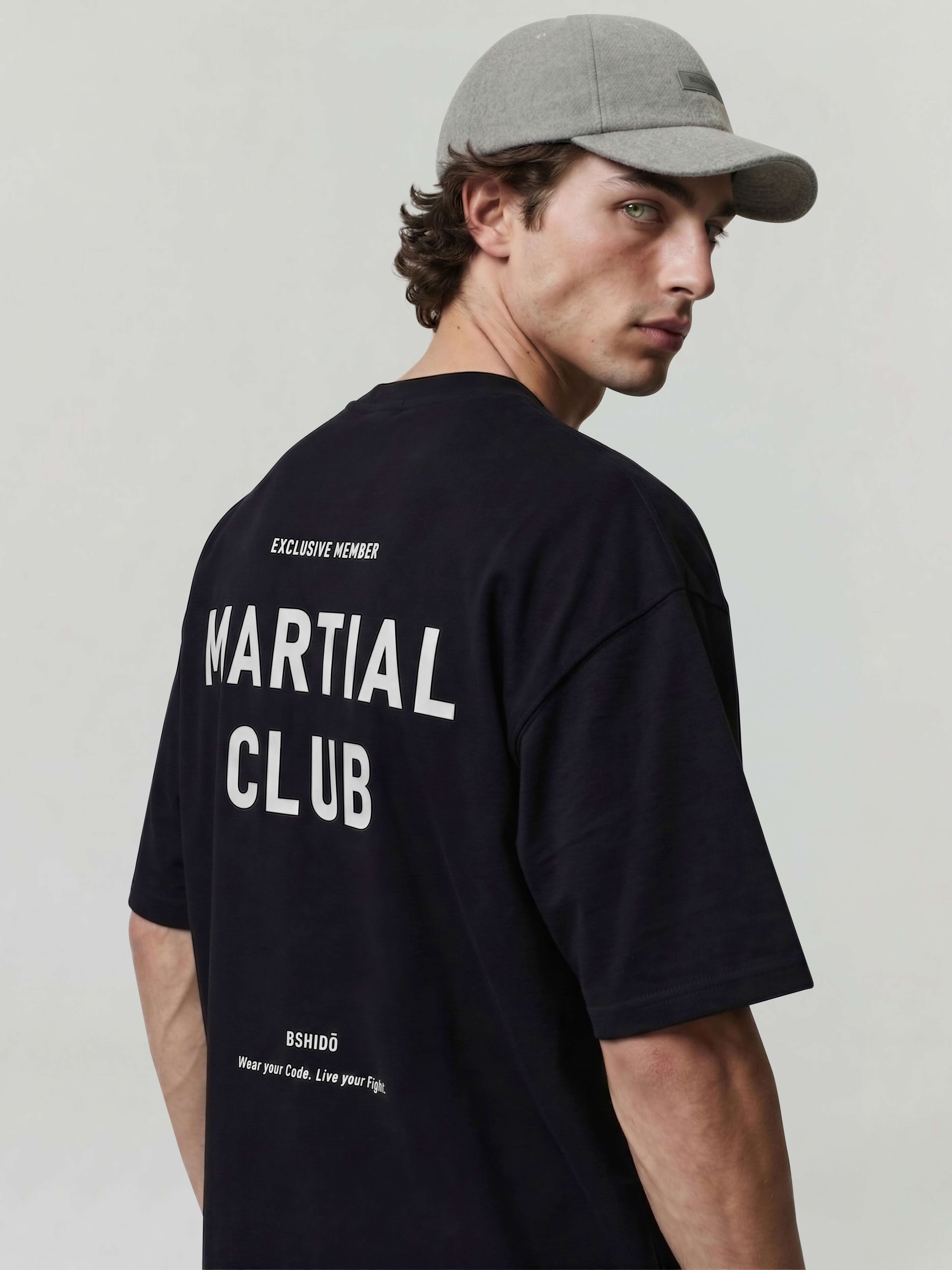 Black oversized Bshido t-shirt back angled view with “Martial Club” and “Exclusive Member” print