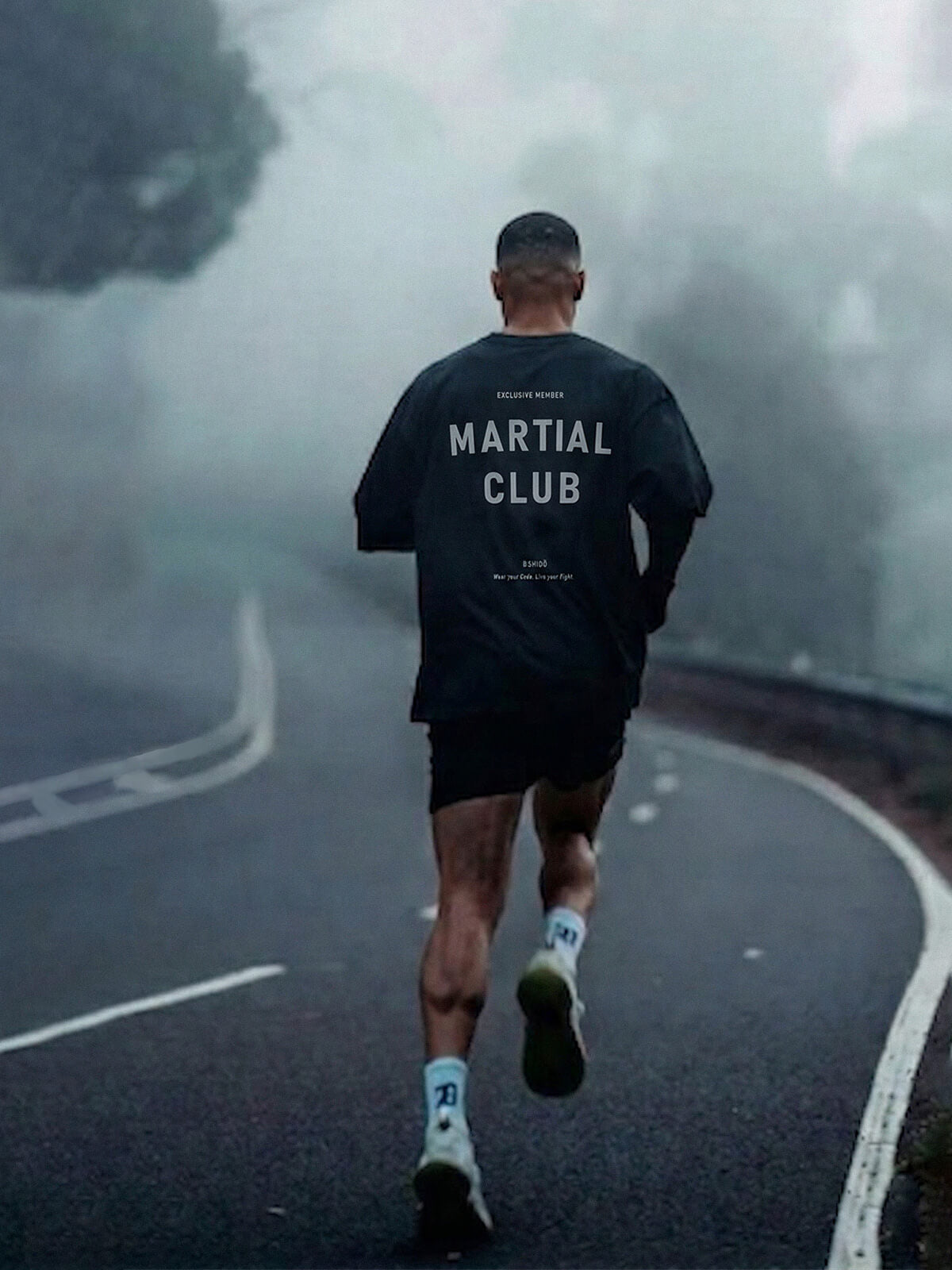Man running on a road wearing a ‘Martial Club’ Bshidō t-shirt.